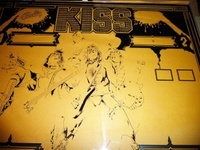 Image # 62115: KISS Partially Screened Backglass - Center 
(First the mirroring was applied, then the black. This clear glass is resting upon brown paper.)