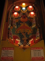 Image # 29185: Balls-A-Poppin Pop Bumpers Lit 
(Hitting the yellow bumper lites the pop bumpers for increased value, turns off the slingshot kicker lights, and turns on lamps under the apron to illuminate the flipper area. Serial number B1710.)