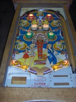Image # 46187: Mademoiselle Illuminated Playfield 
(The white bumper caps on this game have had their existing stampings re-inked by the game owner with a red color, as suggested in the black-and-white flyer.)