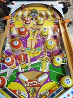 Image # 67419: Majorettes Sample Game - Playfield 
(The four orange clamps shown here are part of a makeshift playfield rotisserie. The owner added a red flipper rubber to the black upper arch rebound rubber. Serial number 01006 S.)