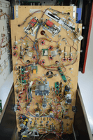 Image # 73483: Mousin' Around! Under Playfield 
(The Trap (Ball Eater) Assembly seen in the lower left corner of this playfield (as viewed in this image, and is partly blue in color) has a metal bracket holding it to the playfield. Reportedly, this bracket was added after-factory to improve stability. See the close-up image in this listing.)