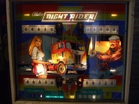 Image # 50352: Night Rider 100,000 Point Thresholds 
(Relays are used to record for each player when 100,000 points are scored. Here, all four player scores are lit in this way. Also, the glass shows that 'Same Player Shoots Again' is lit.)