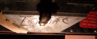 Image # 42242: Planets Inside Front Door - Detail 
(The coin return funnel is marked 'Zodiac'. Serial number 99486. Elsewhere on this game is serial number 99584.)