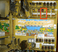 Image # 83194: Race-Way Inside Two Tilt Backbox - Annotated 
(The red rectangle identifies the location of the Tilt Relay. The white square identifies the location of the two Game Over Relays. The dual outlet box is an after-factory modification and the fuse block below it is a replacement. The scenic artwork and white relay strips are reproduction.)