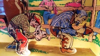 Image # 69240: Rancho Animation Comparison 
(The metal cowboy from a 'Cow Poke' game has been placed in this image to compare it to the plastic cowboy in the 'Rancho' game.)
