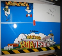 Image # 66996: Red & Ted's Road Show Preliminary Color Test 
(Laminate on wood. The wood would first get a white vinyl laminated to it for printing purposes. A marker was used on letters 'ROA' to test a yellow color rather than white. The orange stripes and yellow letters were ultimately rejected by company management.)