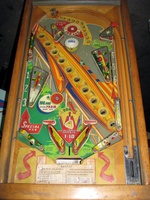 Image # 52398: Rocket Playfield 
(The triangular post between the flippers is not original, and would be round. The red flipper above this post is not original and we do not know if it operates. The posts in the lower left and right corners of the playfield have been moved from their original positions.)