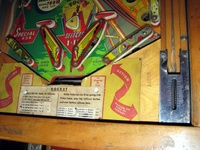 Image # 52403: Rocket Lower Playfield 
(The triangular post between the flippers is not original, and would be round. The red flipper above this post is not original and we do not know if it operates. The posts in the lower left and right corners of the playfield have been moved from their original positions.)