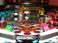 Image # 38886: Rollergames Ball View 
(The rose-colored plastic above the green drop targets and below the pop bumper cap is not original to this game.)