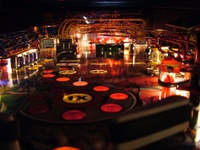 Image # 38888: Rollergames Illuminated Ball View 
(The rose-colored plastic above the green drop targets and below the pop bumper cap is not original to this game.)