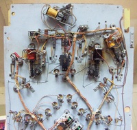 Image # 69132: Safari Under Lower Playfield 
(The factory passive bumper between the flippers, which would appear under the playfield as a simple switch, has been replaced here by a pop bumper coil assembly. Near the left flipper coil is an unidentified relay not present on other games. Serial number 1354.)