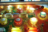 Image # 45306: Show Boat Illuminated Upper Playfield 
(On this playfield, each of the two pairs of blue posts at the top of the playfield should have a white rubber ring stretched between them.)