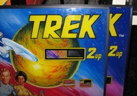 Image # 52948: Star Trek Backglass Comparison - Detail 
(The glass on the left lacks a trademark symbol after the name and no adhesive 'Credit' sticker was applied to the credit window.)