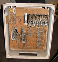 Image # 43120: Straight Flush Inside Backbox 
(The wooden chime box in the upper left corner is missing its coil and solenoid, although the metal chassis remains. The two 1,000,000 point lamps in the upper right corner have their ground wire dangling, unconnected, because it used to be attached to the ground wiring above the hundreds reel until two lamp sockets for two score reels were removed. In the lower half of the insert, one of the two cable connectors has been removed.)