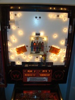 Image # 39440: Big Guns Behind Backglass - Bagatelle Flash Lamps 
(The hole and its two flash lamps at the bottom of the bagatelle were removed from later games. Serial number 557 118502. Date of manufacture was faded but the playfield is stamped with an Oct 30/87 date.)