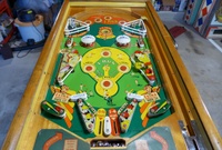 Image # 63510: Hits and Runs Playfield 
(The left-side ballplayer figurine is not original to this game and has been repainted as well. The pop bumper caps and the flippers have been touched up with blue ink. The elevated screws below the flippers are not original to this game. Serial number A1283.)