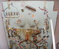 Image # 64255: Miss Universo (3 Ladies) Under Lower Playfield 
(The flipper mechanisms and outhole mechanism have been removed. The left slingshot coil has been removed. Two rollover lane switches on the right have been removed.)