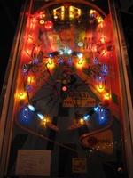 Image # 54289: West Club Illuminated Playfield 
(The top left round yellow rebound rubber is from Bally. The round yellow rebound rubbers at each outlane are from Williams. These parts are not original to this game.)