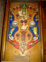 Image # 27670: Canasta Playfield 
(This playfield is missing the two flipper-shaped posts at the very top center of the playfield, above the white post, and where a rubber ring fits around all three of them.)