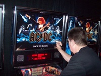 Image # 52340: AC/DC Back In Black (Limited Edition) Signed Backglass 
(Designer Steve Ritchie is signing a backglass at the 2012 Texas Pinball Festival.)