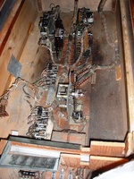 Image # 64297: Cover Girl Inside Cabinet 
(The relay mounted to the cabinet wall is not original to this game. It replaced the original relay and is mounted on the wall because it does not fit in its original place on the motor board where a bare stretch of metal bar is now seen. The square piece of sheet metal stapled to the left wall is not original and was placed temporarily during cabinet repair.)