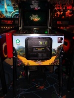 Image # 57427: The Wizard of Oz (Standard Edition) Test Game on Location 
(The red ticket vendor box is attached to the Tron machine. Photographed at the March 2013 ENADA coin-op trade show in Rimini, Italy.)