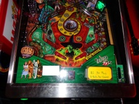 Image # 57425: The Wizard of Oz (Standard Edition) Test Game on Location 
(The red ticket vendor box in the left is attached to the Tron machine. Photographed at the March 2013 ENADA coin-op trade show in Rimini, Italy.)