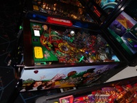 Image # 57426: The Wizard of Oz (Standard Edition) Test Game on Location 
(The red ticket vendor box is attached to the Tron machine. Photographed at the March 2013 ENADA coin-op trade show in Rimini, Italy.)