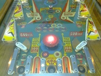 Image # 56437: Cue Ball Lower Playfield 
(The white target and the blue and green pop bumper platters are not original to this game. The top gobble hole has been painted blue.)