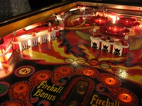 Image # 40267: Fireball II Illuminated Upper Left Playfield 
(The factory mylar has been removed from this playfield. The drop targets and bumper caps are after-factory manufacture using Bally's original dies.)