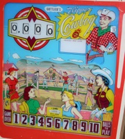 Image # 37592: Flipper Cowboy Backglass 
(An after-factory replay unit has been added to this game, photographed at the 2006 Vierzon Pinball Show in France. We retain this image to show the other features of this backglass.)