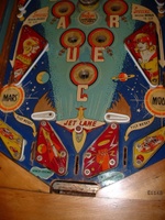 Image # 58735: Flying Saucers Lower Playfield 
(The white pop bumper cap printed with 'VENUS' is missing at the top of this picture. The words 'Tilt Reset' are inexplicably missing from the playfield directly below the red post between the flippers.)