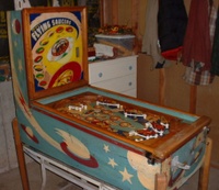 Image # 58736: Flying Saucers Cabinet - Full View 
(A coat of brown paint has been removed from the cabinet and rails, and from the playfield apron and trim. The white pop bumper cap printed with 'VENUS' is missing from the playfield.)
