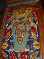 Image # 58733: Flying Saucers Playfield 
(The white pop bumper cap printed with 'VENUS' is missing in this picture. The words 'Tilt Reset' are inexplicably missing from the playfield directly below the red post between the flippers.)